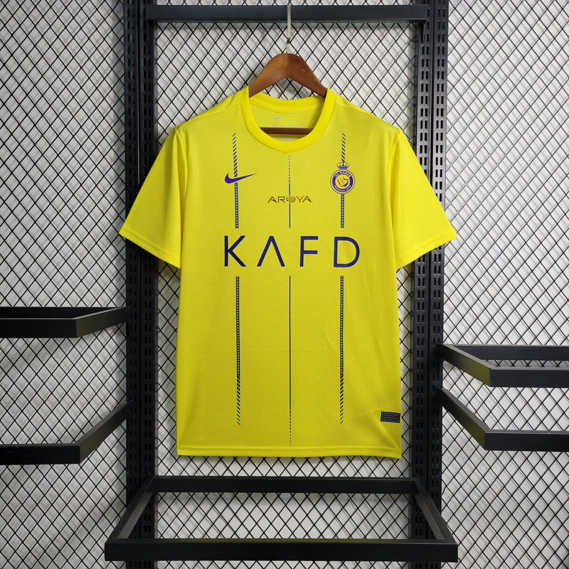camisa-camiseta-al-nassr-kafd-nike-versao-versao-torcedor-masculina-23-24-home-casa-i-principal-1-cr7-cristiano-ronaldo-talisca-anderson-amarela-amarelo-azul_1