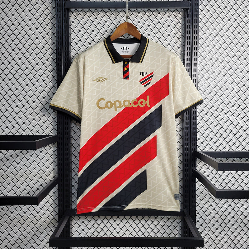 camisa-camiseta-cap-athletico-paranaense-umbro-copacol-versao-versao-torcedor-masculina-23-24-edicao-edicao-especial-dourado-dourada-vermelha-preta-vermelho-preto-bege_1